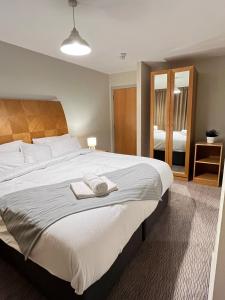 a bedroom with a large bed with towels on it at Comfy 2bed flat next to Motorpoint Arena in Nottingham