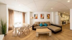 a living room with a couch and a table at Apartamento moderno en el centro de Tavernes in Tavernes de Valldigna