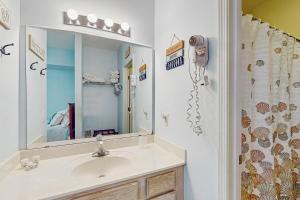 a bathroom with a sink and a shower at SB50 Saltwater Sanctuary in Sunset Beach +18 photos