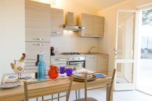 a kitchen with a table with a chicken on it at Villa Ginanneschi - Le Pitte in Capoliveri +8 photos