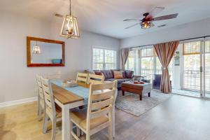 a living room with a table and a couch at SB72 Sea Trail Golf-Beach Condo in Sunset Beach