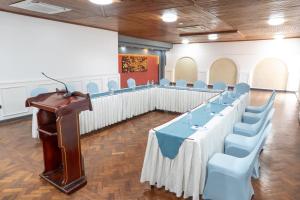a conference room with a long table and blue chairs at Afro Park Hotel in Kampala +84 photos