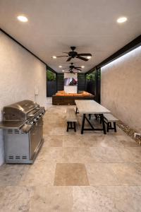 a large patio with a table and a grill at Villa Miami Lakes 2 in Hialeah