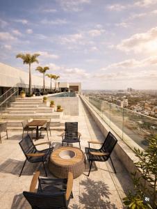 a patio with chairs and tables on a building at Palazzo Torquetti in Belo Horizonte