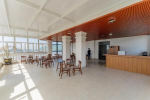 a large room with tables and chairs in a building at Loc Binh Hotel in Thôn Phú An