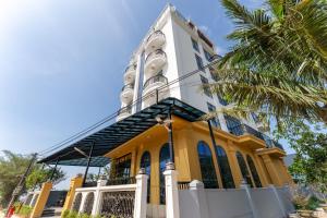 a yellow and white church with a tower at Loc Binh Hotel in Thôn Phú An