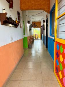 a hallway of a school with colorful walls and a tile floor at Hotel Kali Huasteca in Ciudad Valles