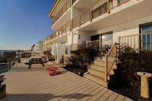 a building with a picnic table on a wooden deck at Bayfront Bliss Your Waterfront Getaway in Ocean City