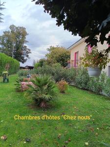 a yard with a house with plants and a garden at Chambres d'hôtes Chez nous in Nantheuil