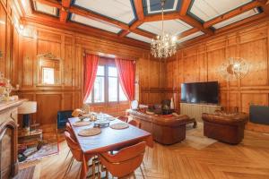 a large living room with a table and a couch at Prestige Étretat in Étretat