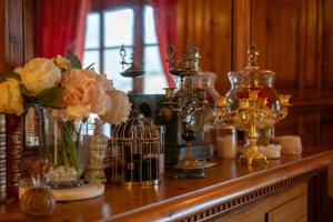 a wooden table with vases and flowers on it at Prestige Étretat in Étretat