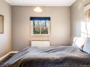 a bedroom with a bed and a window at Tranquil Retreat in Skaerbaek in Skærbæk