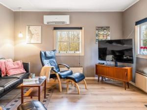 a living room with a couch and a tv at Tranquil Retreat in Skaerbaek in Skærbæk