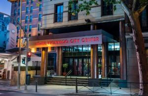a building with a sign for a city center at Leonardo Hotel Madrid City Center in Madrid