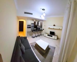 a living room with a couch and a table at Beachfront luxury Palm Beach Piazza Private Beach in Hurghada