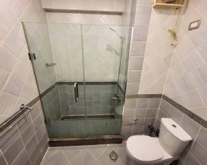 a bathroom with a toilet and a glass shower at Beachfront luxury Palm Beach Piazza Private Beach in Hurghada +7 photos