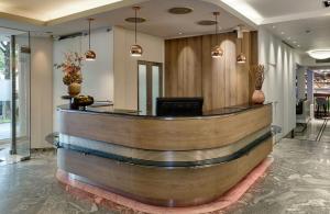 a lobby with a reception desk in a building at Leonardo Hotel München City West in Munich