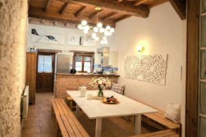 a kitchen and dining room with a table with flowers on it at El Juacu in Llanes
