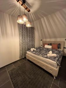 a bedroom with a bed with two towels on it at Crassula Lux 4 in Surčin