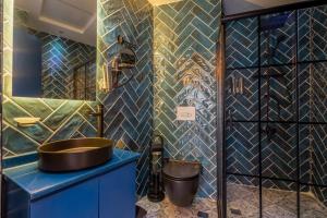 a bathroom with a sink and a blue cabinet at Lidar Hotel Business Class in Urfa +48 photos
