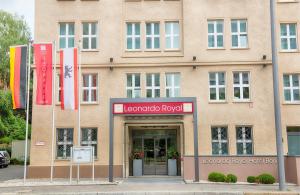 a building with flags in front of it at Leonardo Royal Hotel Berlin Alexanderplatz in Berlin