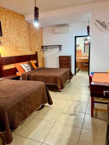 a hotel room with two beds and a mirror at Hotel Kali Huasteca in Ciudad Valles