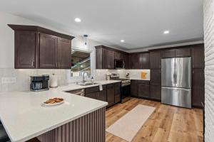 a kitchen with wooden cabinets and stainless steel appliances at The Covington Haus in Minnetonka