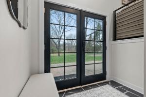 a room with black doors and a window at The Covington Haus in Minnetonka