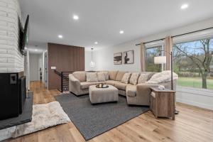 a living room with a couch and a tv at The Covington Haus in Minnetonka +55 photos