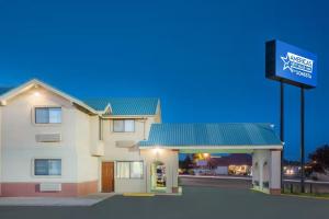 a building with a sign in front of it at Americas Best Value Inn Hobbs in Hobbs