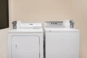 two refrigerators are next to each other in a room at Americas Best Value Inn Hobbs in Hobbs +12 photos
