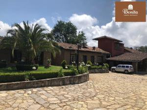 a house with a car parked in front of it at Quinta Bonita in Zacatlán