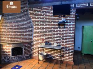 a brick wall with a fireplace and a television at Quinta Bonita in Zacatlán +11 photos