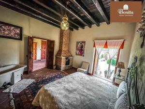 a bedroom with a large bed and a fireplace at Quinta Bonita in Zacatlán