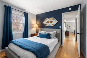 a bedroom with blue walls and a large bed at The Nicollet Nook Unit 2 in Minneapolis