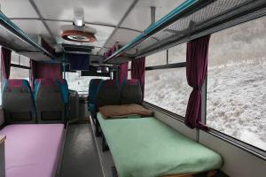 an inside view of a bus with colorful seats at Bed in Bus in Kolárovice