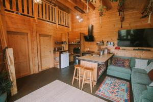 a living room with a couch and a bar in a cabin at Twizel Ecostays in Twizel