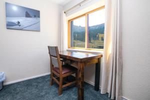 a wooden desk in a room with a window at Ski in out King bed Suite Mountain View in Kirkwood