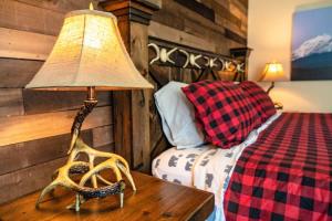 a bedroom with a bed and a lamp on a table at Ski in out King bed Suite Mountain View in Kirkwood
