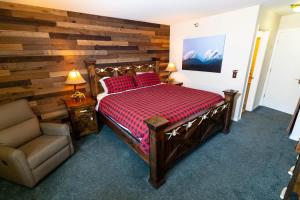 a bedroom with a bed and a chair in it at Ski in out King bed Suite Mountain View in Kirkwood