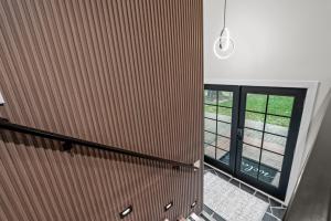 a staircase with a wooden wall and a window at The Covington Haus in Minnetonka