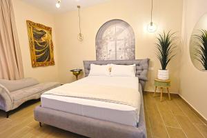 a bedroom with a bed and a chair at Jera Rooms in Durrës