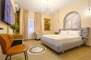 a bedroom with a bed and a chair at Jera Rooms in Durrës +43 photos