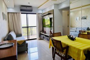 a living room with a yellow table and a couch at Detalhes que te convida a aproveitar in Sorocaba