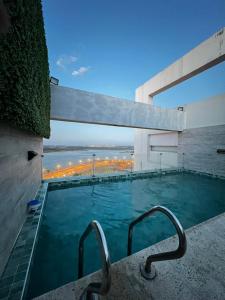 a swimming pool with a view of a building at The One DownTown Costanera in Asunción