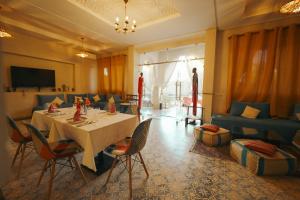 a dining room with a table and a couch at Riad Safran Ralya in Marrakesh