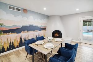 a dining room with a table and chairs and a fireplace at Spacious Scottsdale Getaway with Pool in Tempe