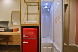 a red refrigerator in a room with a mirror at 통영 하운드호텔 죽림점 in Naejuk-to +31 photos