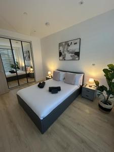 a bedroom with a large bed and a potted plant at 37 Syward Place in Chertsey