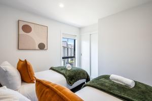a bedroom with two beds and a window at Flexible Bed Options, Private Back Yard, Car Park in Albert Town